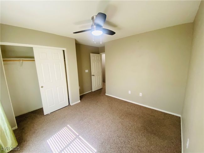 Unfurnished bedroom with a closet, carpet floors, baseboards, and ceiling fan | Image 19