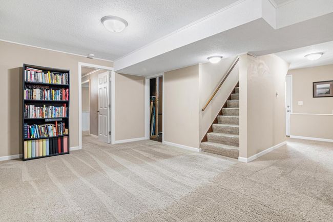 View looking towards the large bedroom, utility / laundry room, and a hallway leading to an office/den, bathroom and door going to the backyard. This home has tons of storage space! | Image 15