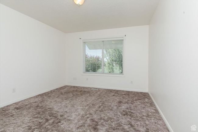 Carpeted empty room featuring baseboards | Image 22
