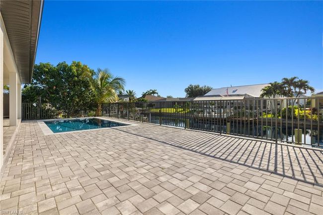 View of swimming pool featuring a patio area and a water view | Image 39