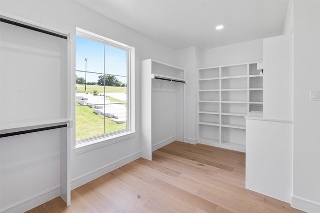 Primary closet with built many built in features | Image 19