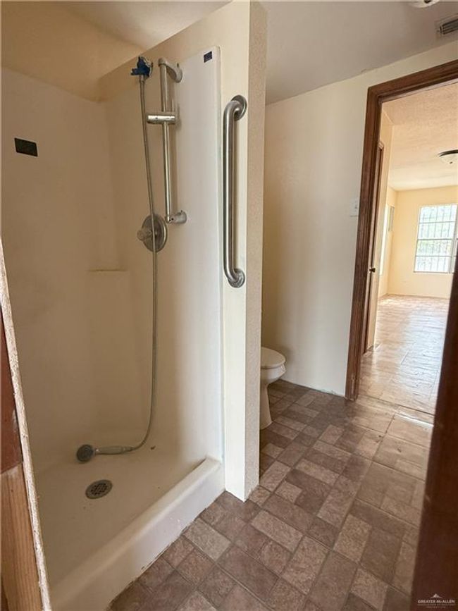 Bathroom with toilet, visible vents, and a stall shower | Image 15