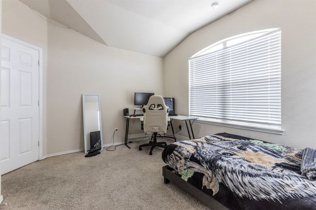 Carpeted bedroom featuring baseboards and vaulted ceiling | Image 25