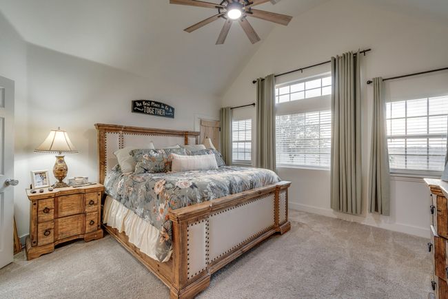 Carpeted bedroom with ceiling fan and high vaulted ceiling | Image 12