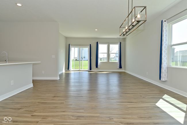 unfurnished dining area featuring a chandelier, light wood finished floors, baseboards, and recessed lighting | Image 5