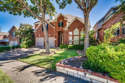 View of front property featuring a front lawn and a garage | Image 2