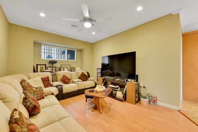 Living room with wood finished floors, ceiling fan, recessed lighting, and baseboards | Image 21