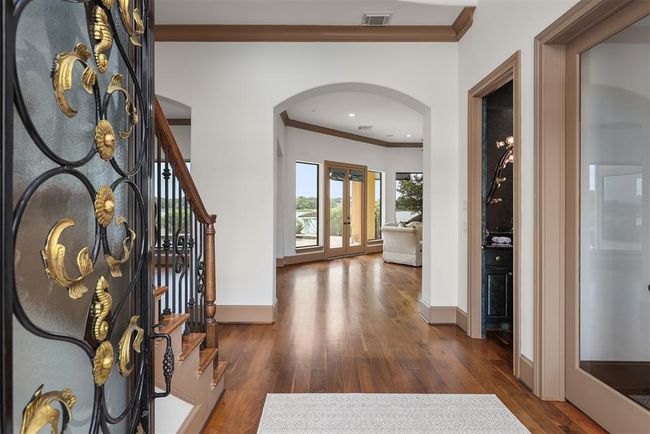The beautiful double doors open to a unique foyer which perfectly captures the WOW factor of the home's water views. | Image 7