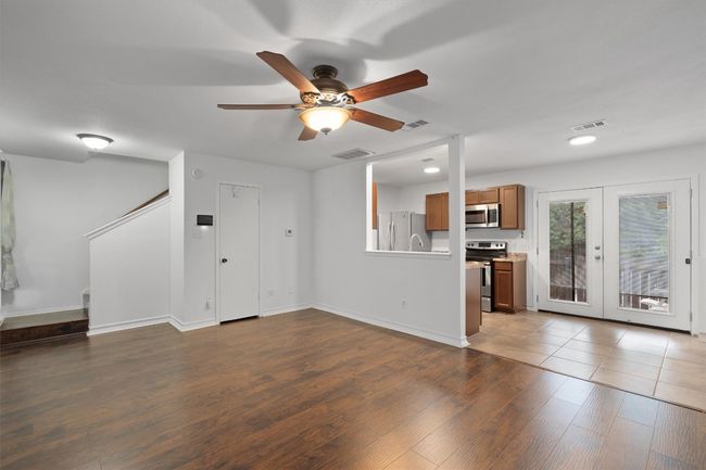 Unfurnished living room featuring ceiling fan, wood finished floors, recessed lighting, and french doors | Image 11