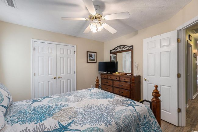 Bedroom featuring a closet, wood finished floors, and a ceiling fan | Image 27