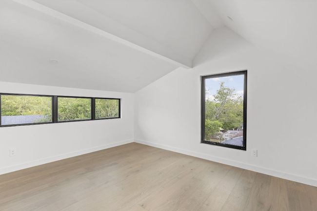 Additional living space with lofted ceiling and light wood-type flooring | Image 30