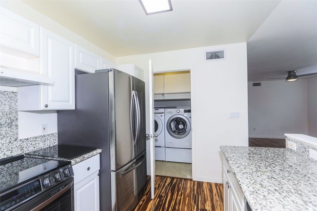 Kitchen view with enclosed laundry room. | Image 6