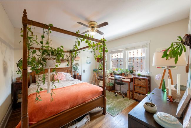 Bedroom with wood finished floors, a ceiling fan, and a desk | Image 14