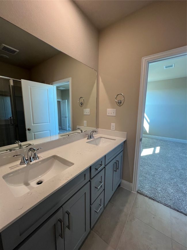 Full bath with double vanity, a sink, and visible vents | Image 7