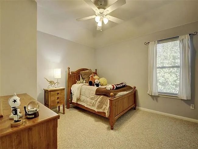 Bedroom with light colored carpet and a ceiling fan | Image 19