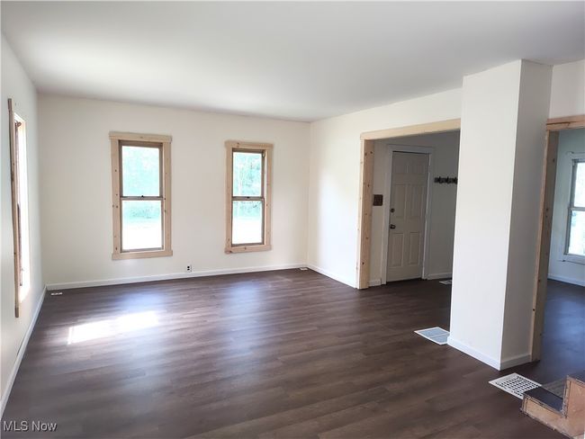 Unfurnished room featuring dark wood-style floors and baseboards | Image 17