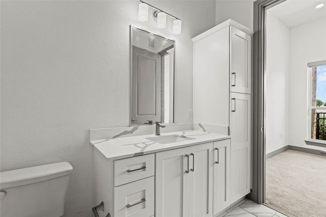 Bathroom featuring toilet and vanity | Image 19