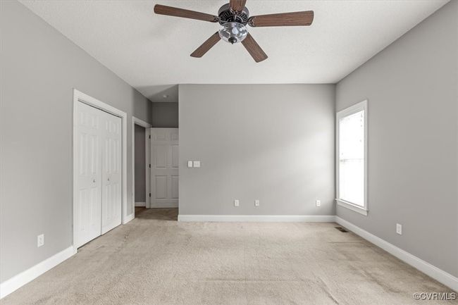 Unfurnished bedroom with light carpet, baseboards, and a closet | Image 28