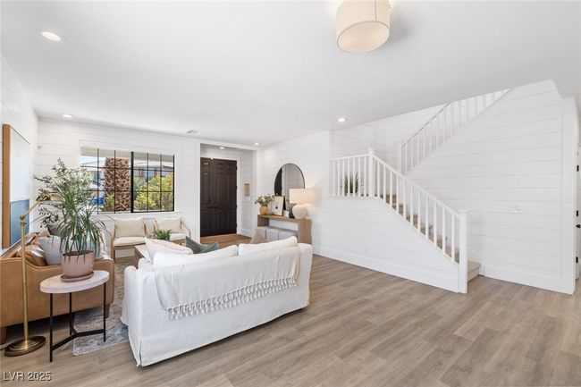 Living room with recessed lighting, wood finished floors, and stairway | Image 5
