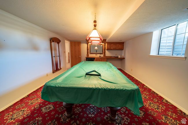 Game room with wet bar. Pool table included in sale. | Image 36