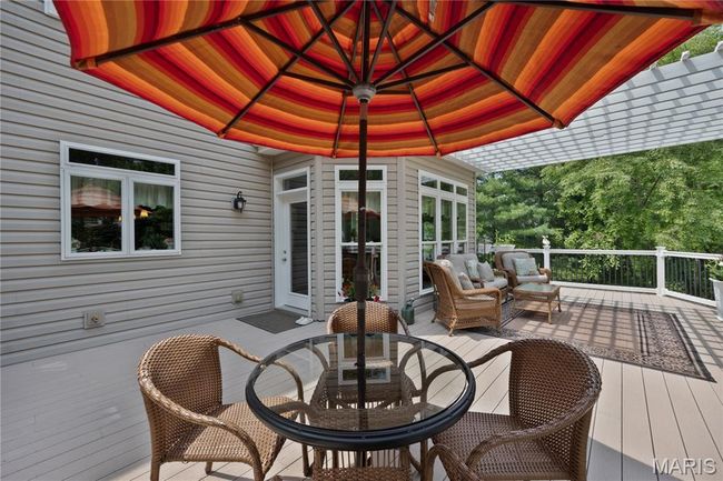 Wooden deck featuring an outdoor hangout area and outdoor dining space | Image 62