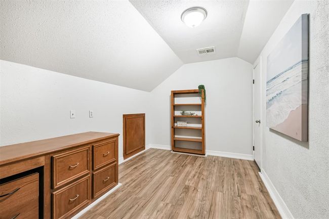 Discover the versatile bonus room above the garage, perfect for an office, gym, or extra storage. | Image 38