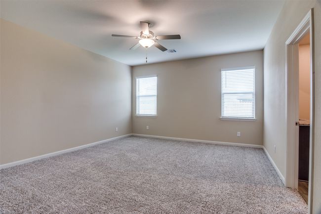 Empty room featuring light colored carpet, ceiling fan, baseboards, and visible vents | Image 7