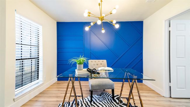 Office featuring light wood-type flooring, a notable chandelier, and baseboards | Image 17