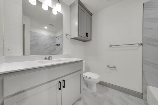Bathroom featuring vanity, toilet, visible vents, marble finish floor, and a tile shower | Image 28