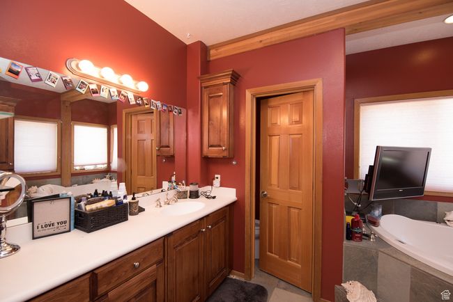 Bathroom featuring a bath, vanity, and tile patterned flooring | Image 62