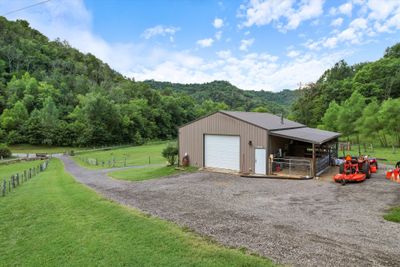 This oversized shop is perfect for all the farm toys, trucks, cars, etc. It also has a full bath and a separate room inside as well as animal stalls under the overhang. | Image 3