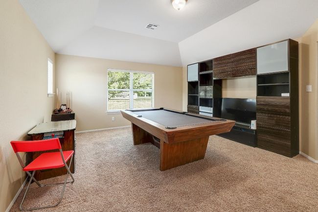 The game room offers a versatile space for fun and relaxation, with enough room for everything from a pool table to cozy movie nights, making it the perfect spot for unwinding or hosting friends | Image 26