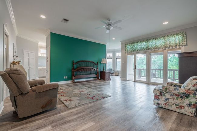 Bedroom with access to outside, crown molding, wood floors, recessed lighting, and baseboards | Image 19