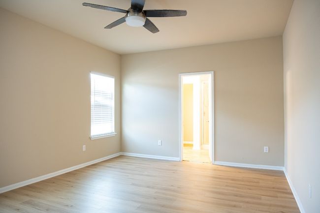 Spare room featuring ceiling fan, light wood-type flooring, and baseboards | Image 12