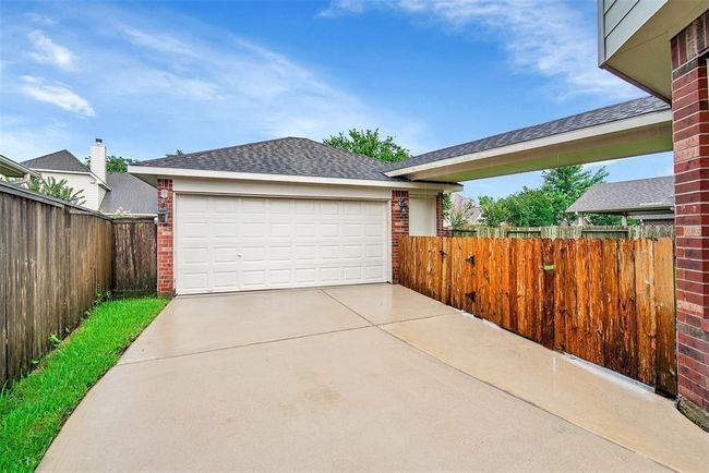 Home offers a two car detached garage and a super long driveway - perfect for parking addtional vehicles. | Image 26