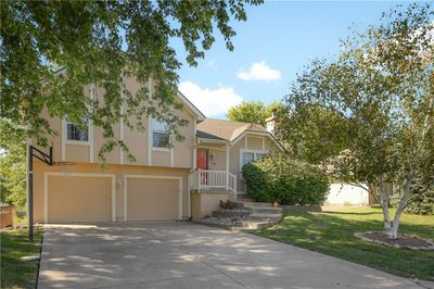 View of front of home with a front yard and a garage | Image 2