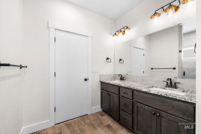 Full bath featuring double vanity and wood finished floors | Image 8