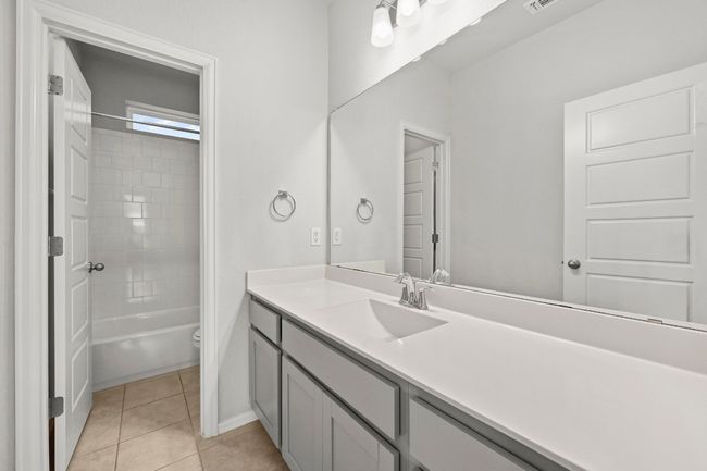 Bathroom featuring vanity, tile patterned floors, and shower / bath combination | Image 28