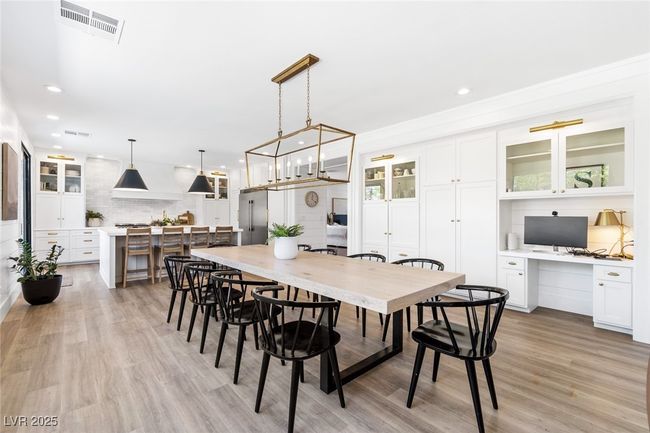 Dining area featuring recessed lighting, built in study area, light wood-style flooring, and visible vents | Image 22
