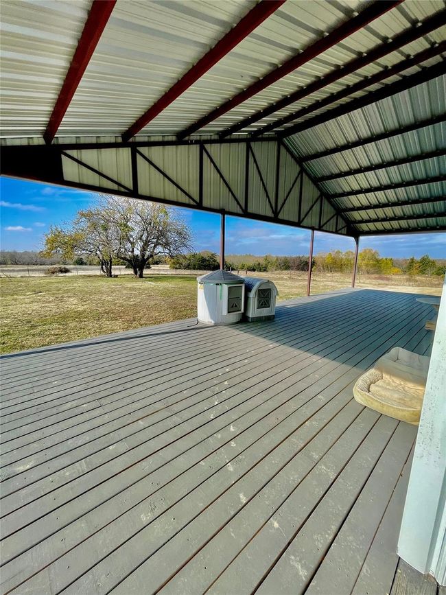 Dock area featuring a wooden deck and a yard | Image 21