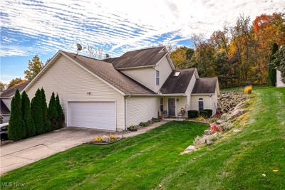 View of property featuring a front yard and a garage | Image 3