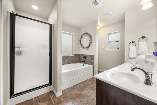 Bathroom with a shower stall, a garden tub, and vanity | Image 17