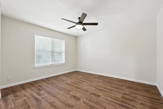 Unfurnished room featuring a ceiling fan and wood finished floors | Image 7