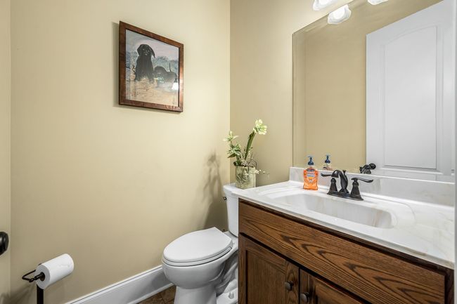Guest bath downstairs has tile flooring and granite countertops. | Image 45
