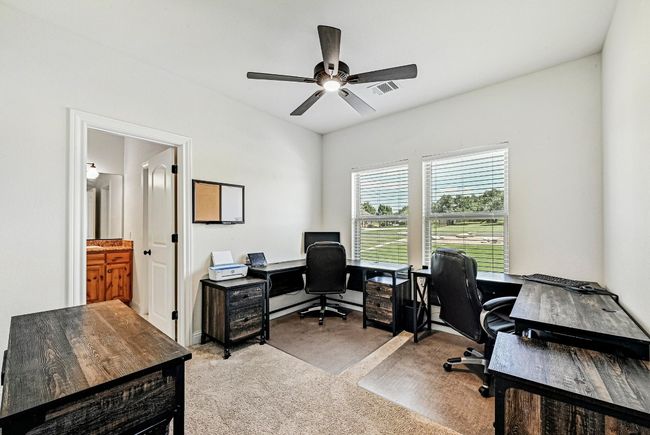 Home office with ceiling fan and light colored carpet | Image 26