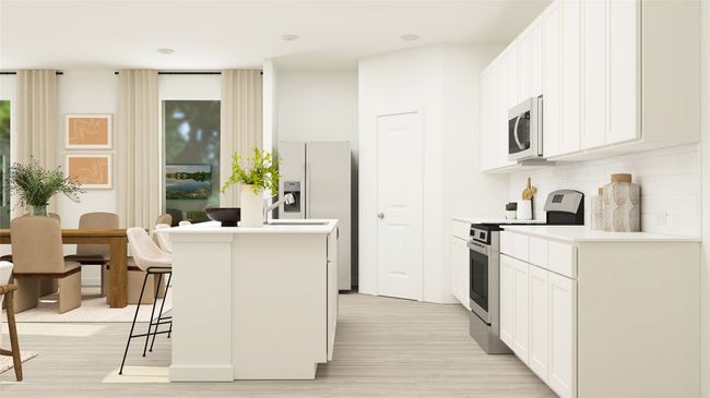 Kitchen with white appliances, light wood-style flooring, a kitchen bar, a center island with sink, and white cabinetry | Image 12