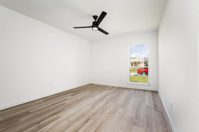 Spare room featuring baseboards, ceiling fan, and light wood-style floors | Image 25