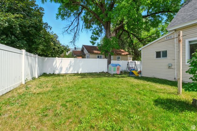 View of fenced backyard | Image 19