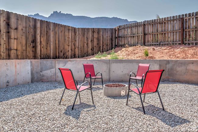Fenced backyard featuring a mountain view, an outdoor fire pit, and a patio area | Image 23