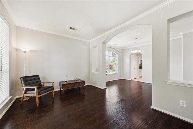 View from the den to the dining room and pantry with the utility room located opposite the pantry. | Image 10